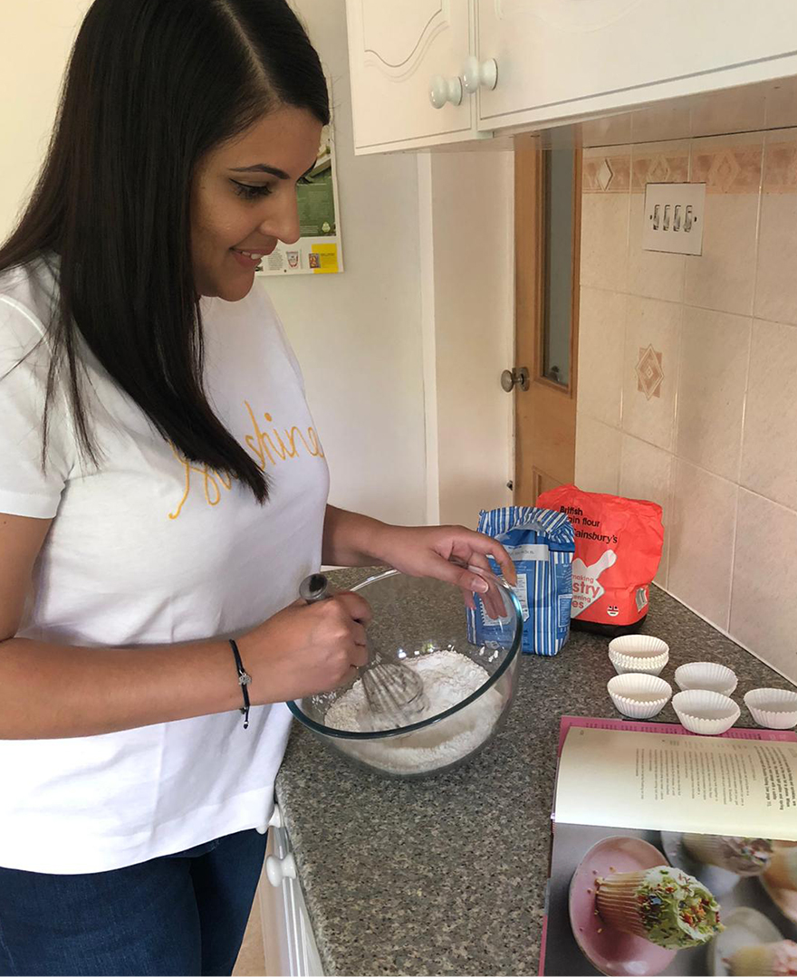 Priya bakes at home wearing the Hobbs sunshine t-shirt and gia sculpting jean