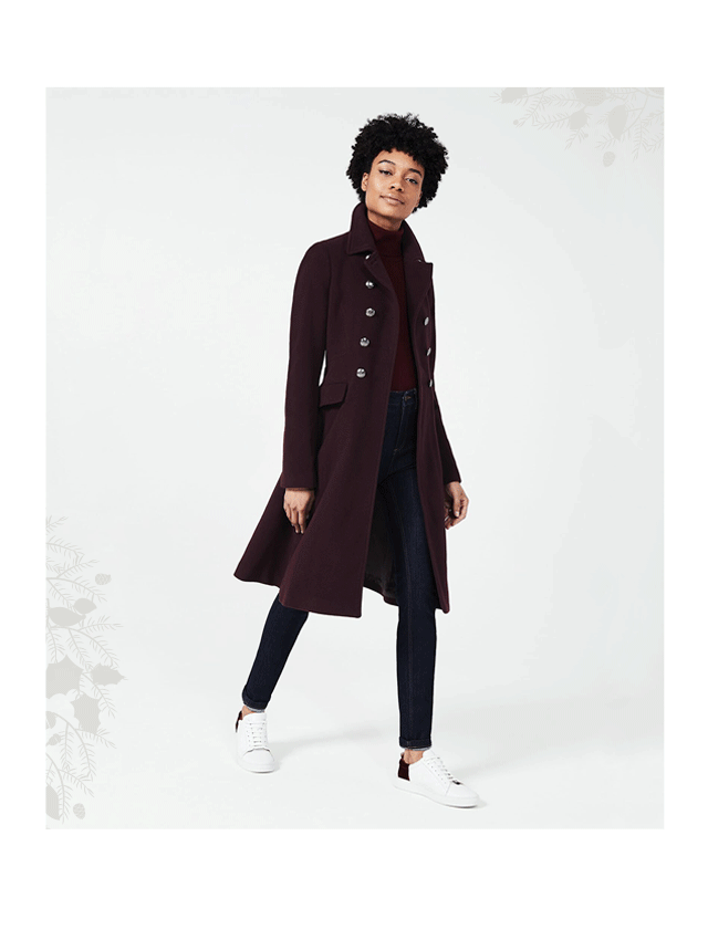 Model wears a plum coloured wool coat from Hobbs.