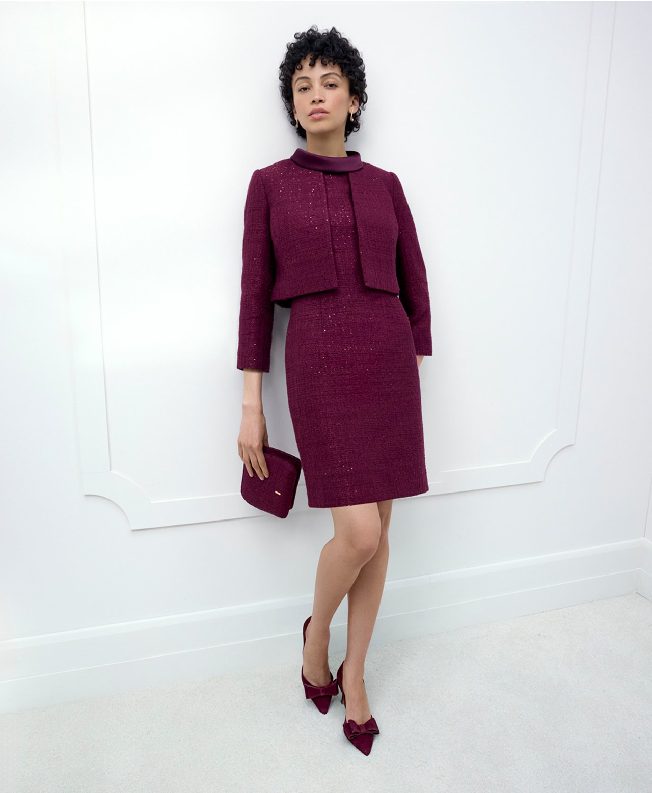 A woman wearing a Hobbs occasion dress and co-ordinating jacket.