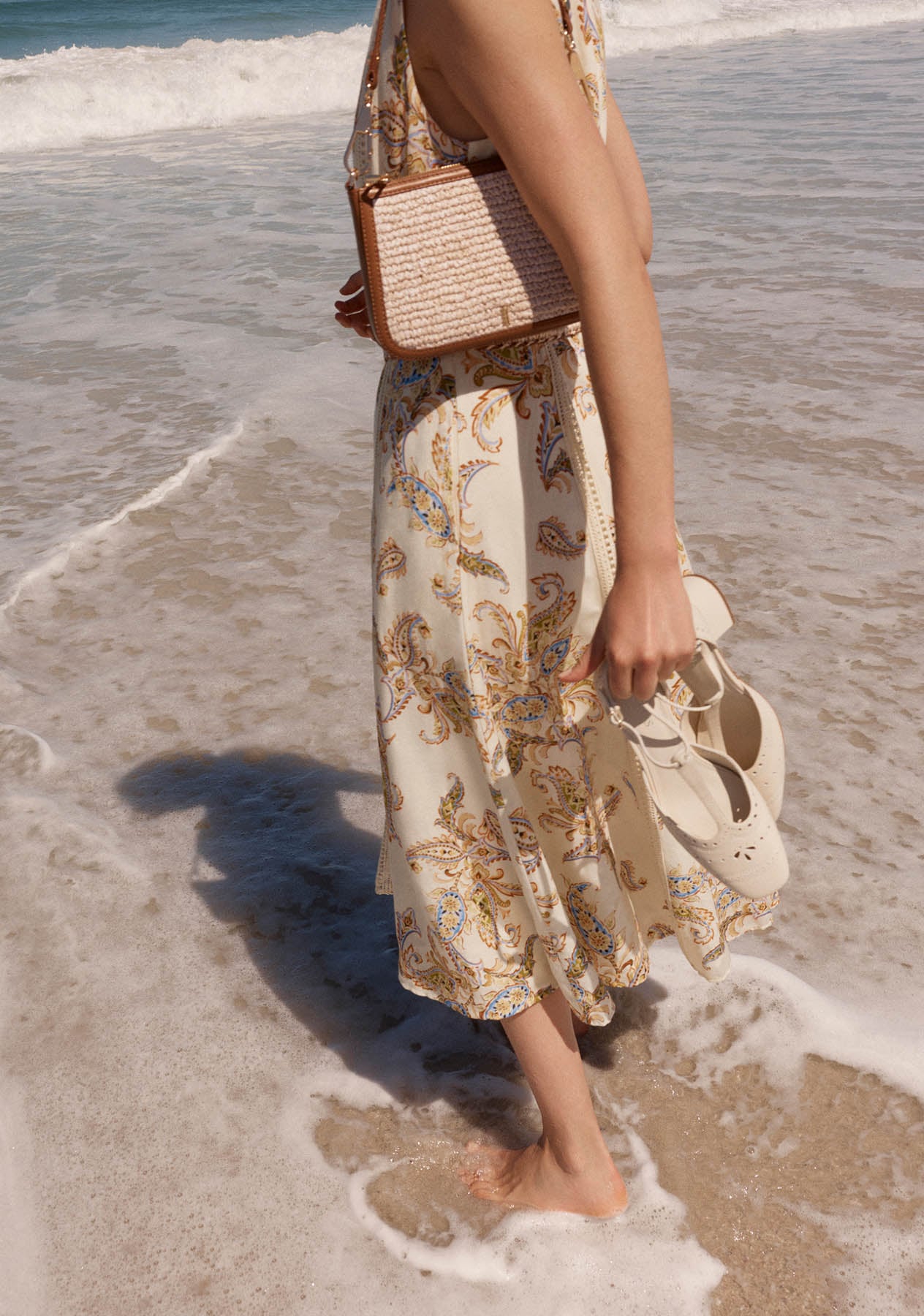 A woman wearing a Hobbs paisley dress