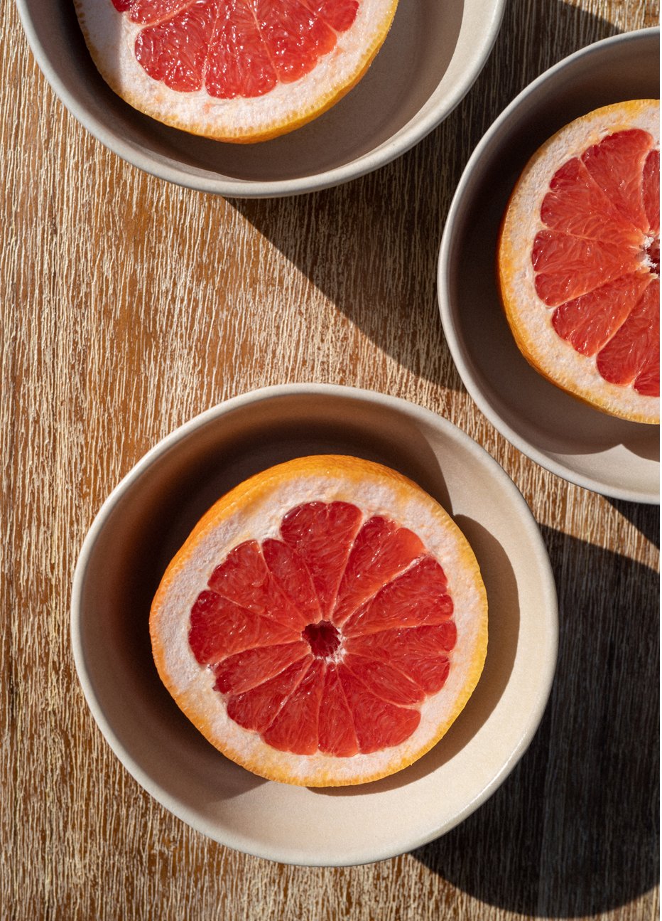 Photograph of sliced grapefruit in bowls, captured by photographer Charlotte Bland.