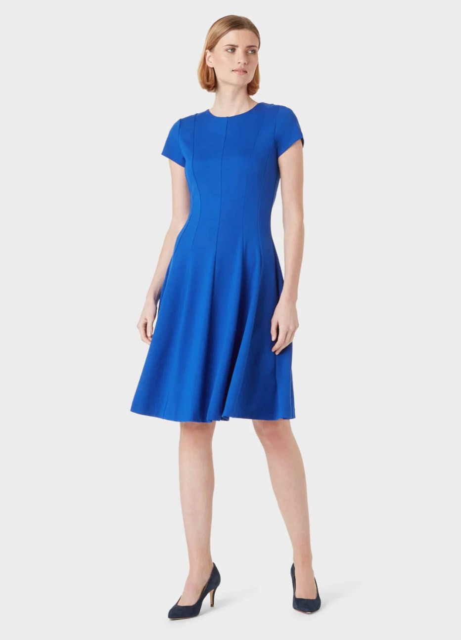 Blue fit and flare work dress with black court shoes by Hobbs.