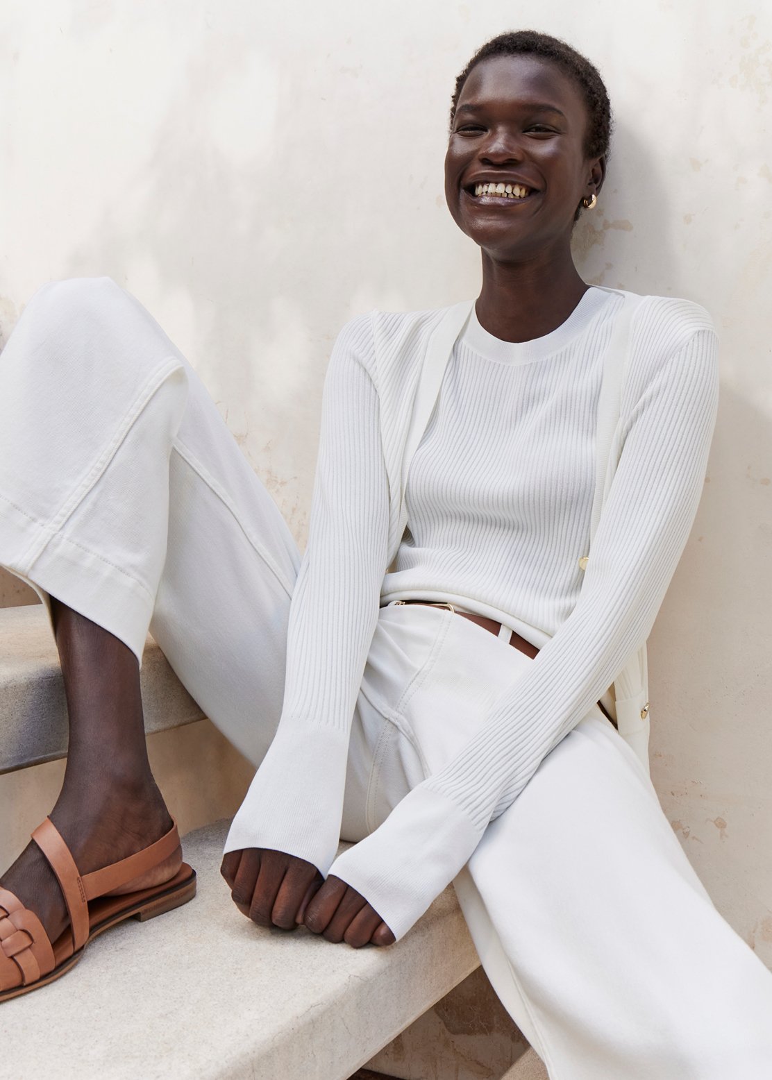 A woman wearing an all-white Hobbs outfit.