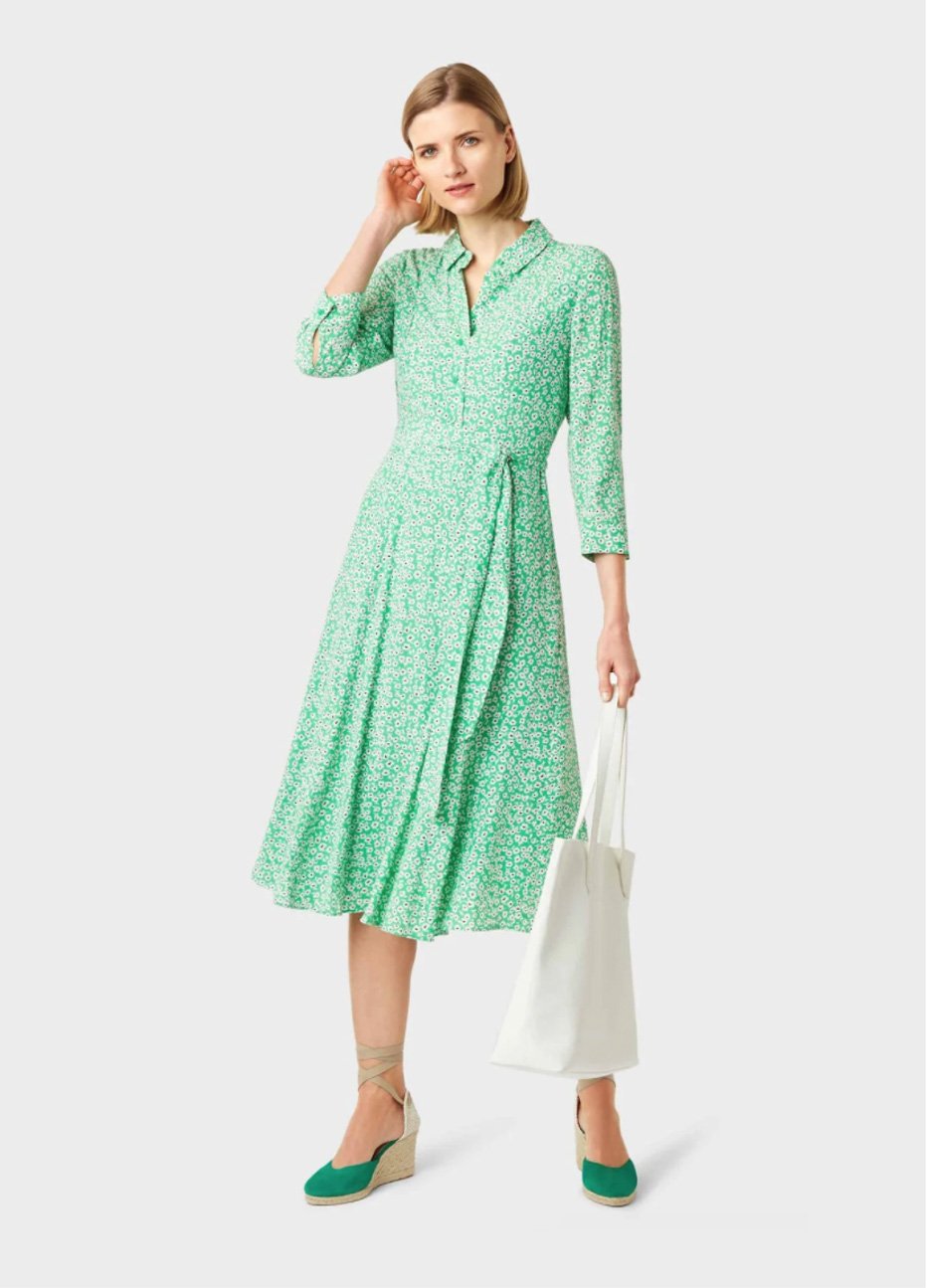 Mid-sleeved fit and flare shirt dress in green with a waist-tie detail paired with green wedge espadrilles with a white leather tote bag, a smart casual look for women by Hobbs.