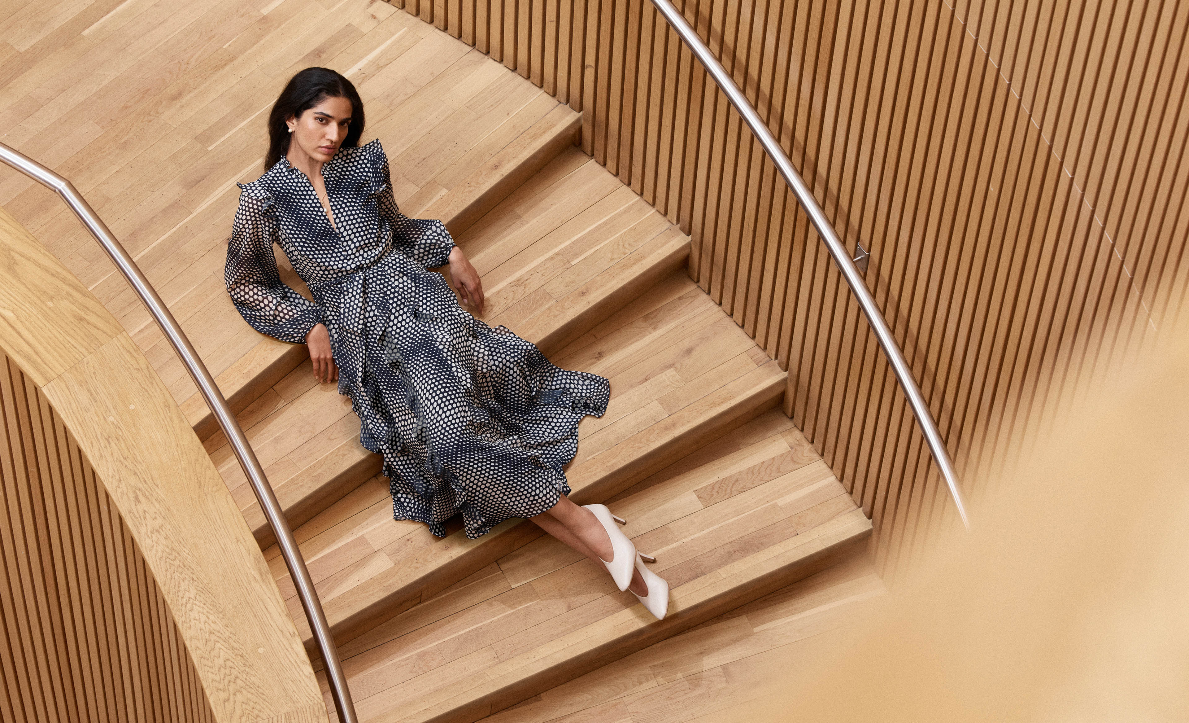 A woman wearing a ruffle polka dot dress.