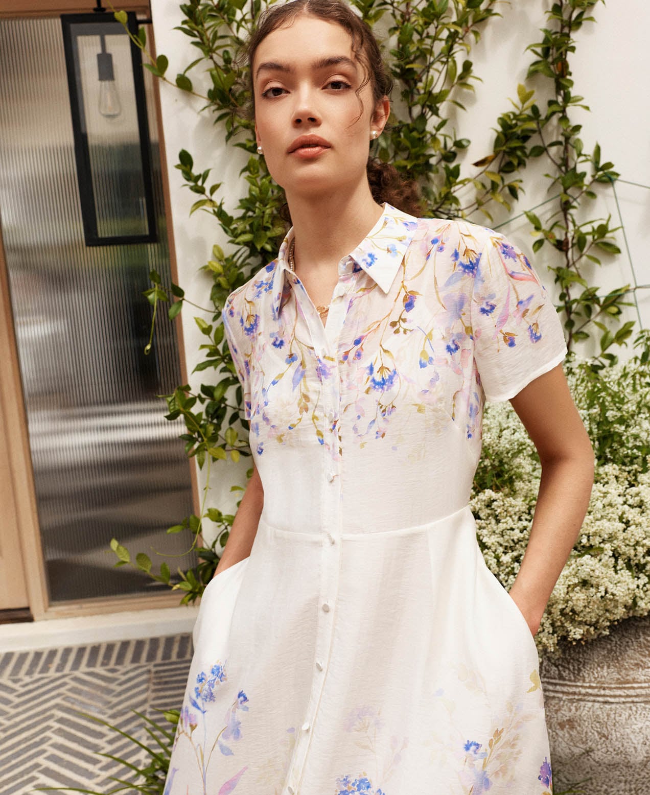 A woman wearing a Hobbs summer dress.