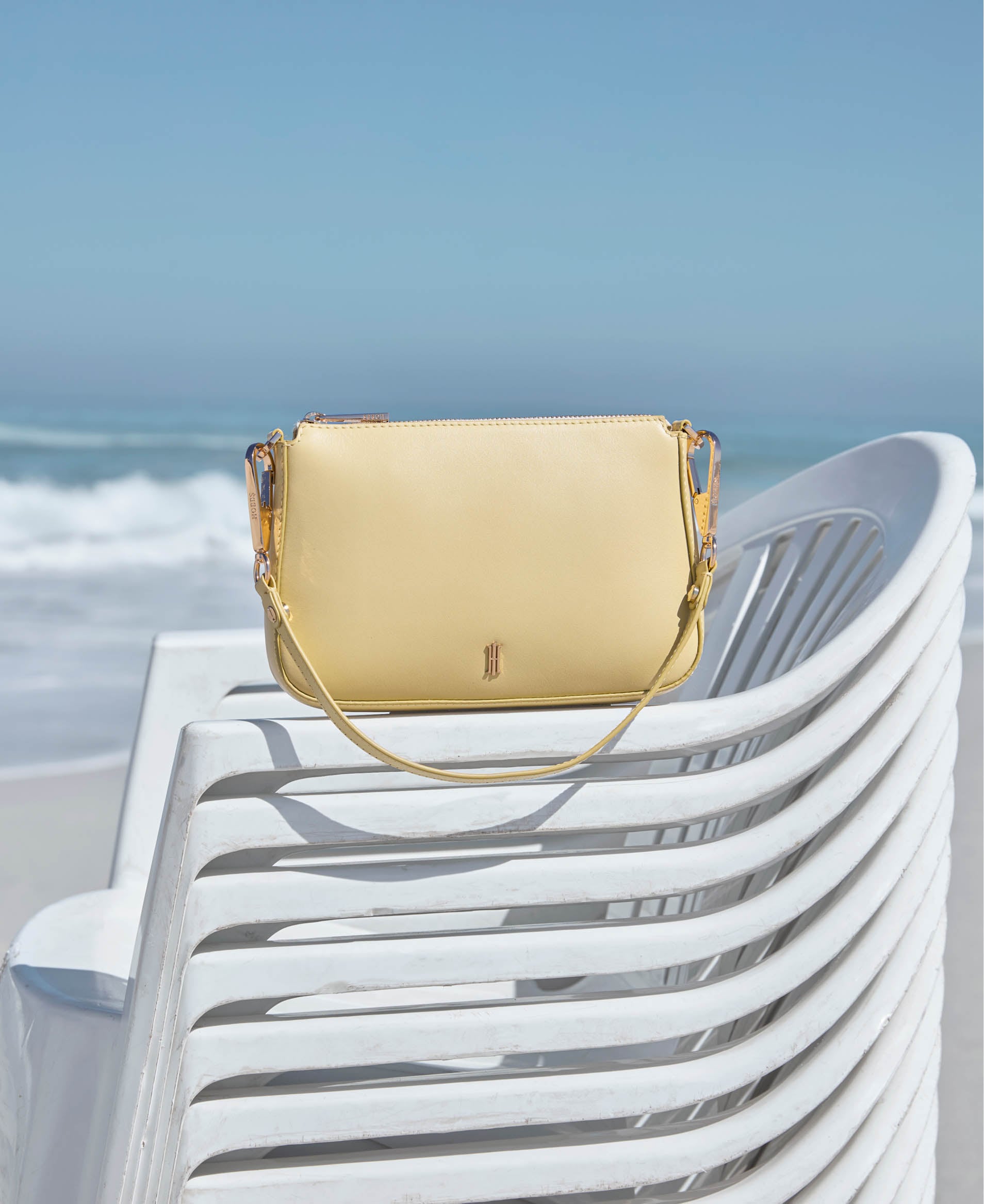 An image of Hobbs’ butter yellow sandals and bags