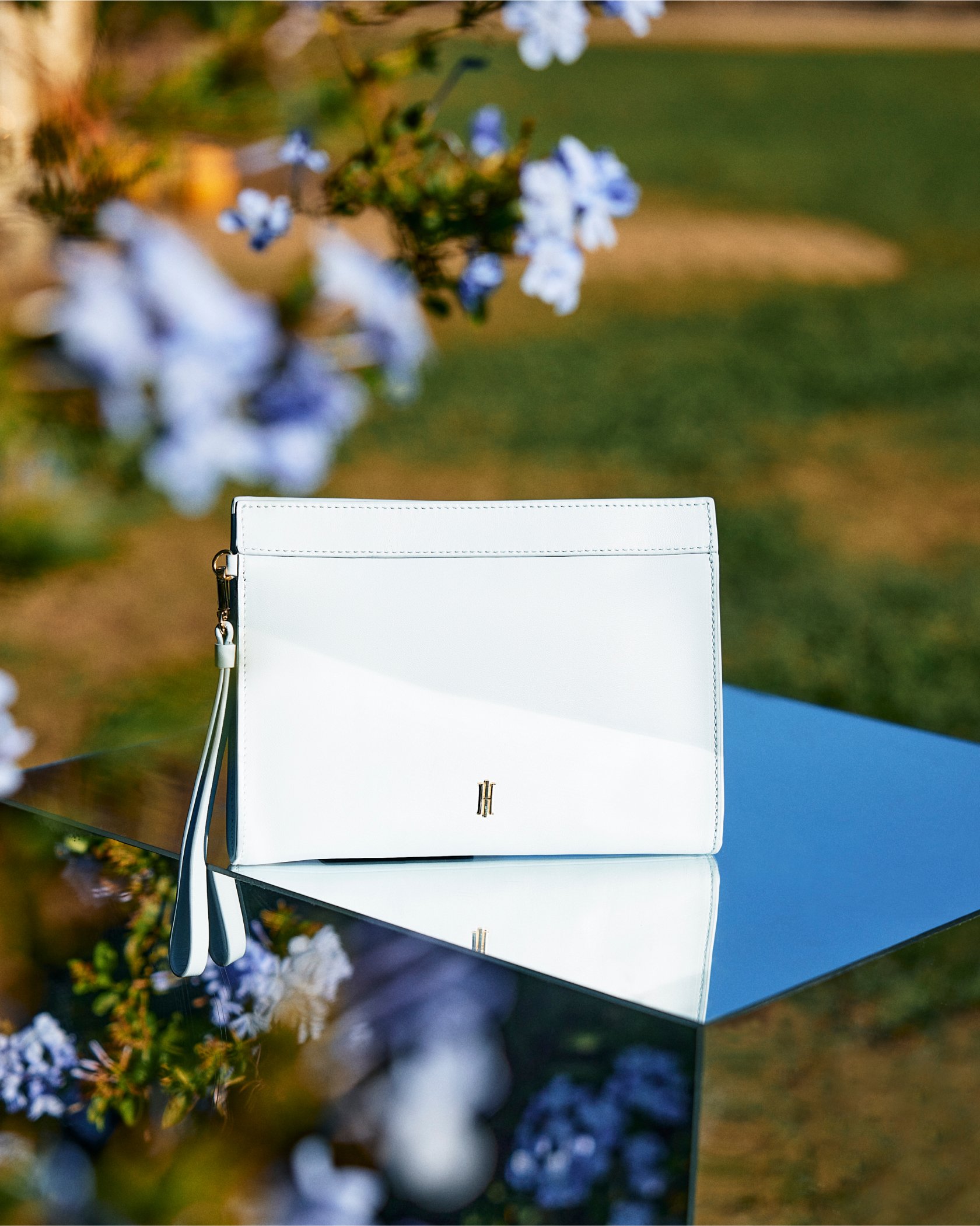 An image of a pale blue clutch bag by Hobbs.