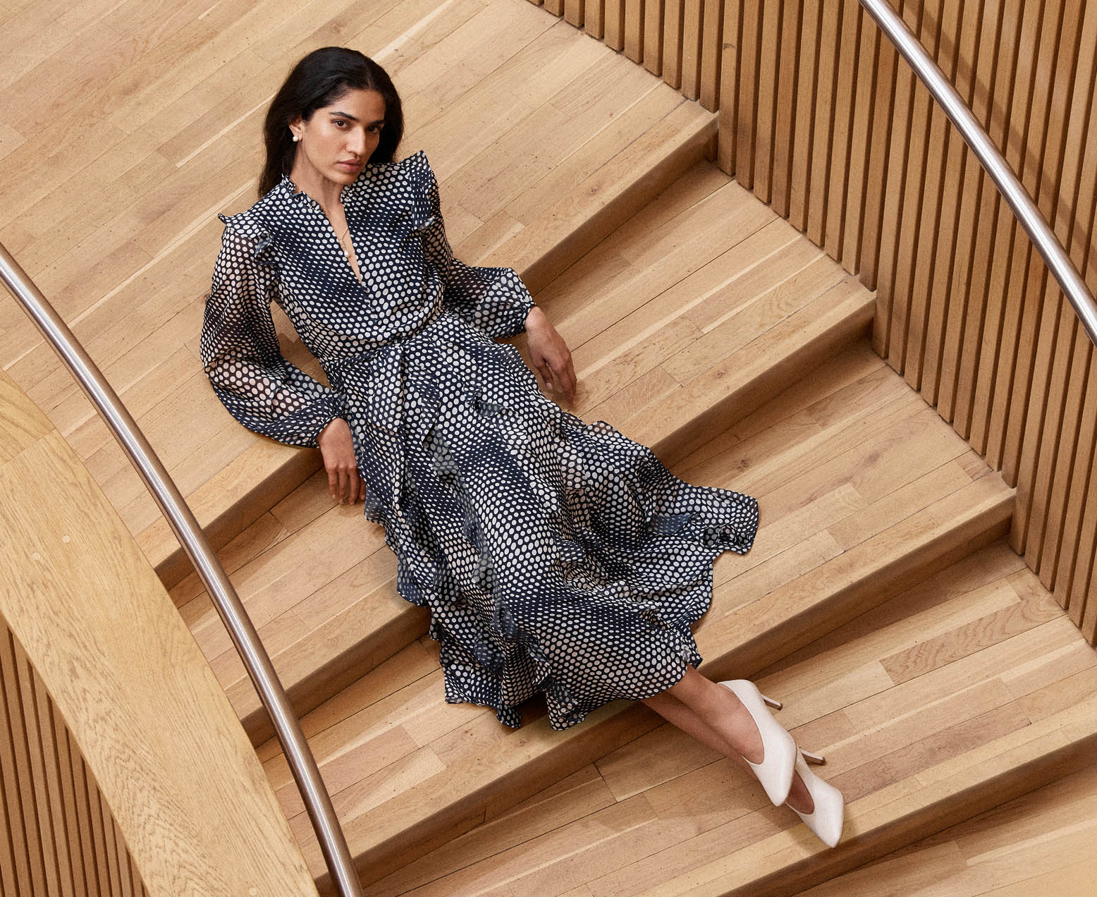 A woman wearing a blush pink occasion outfit.