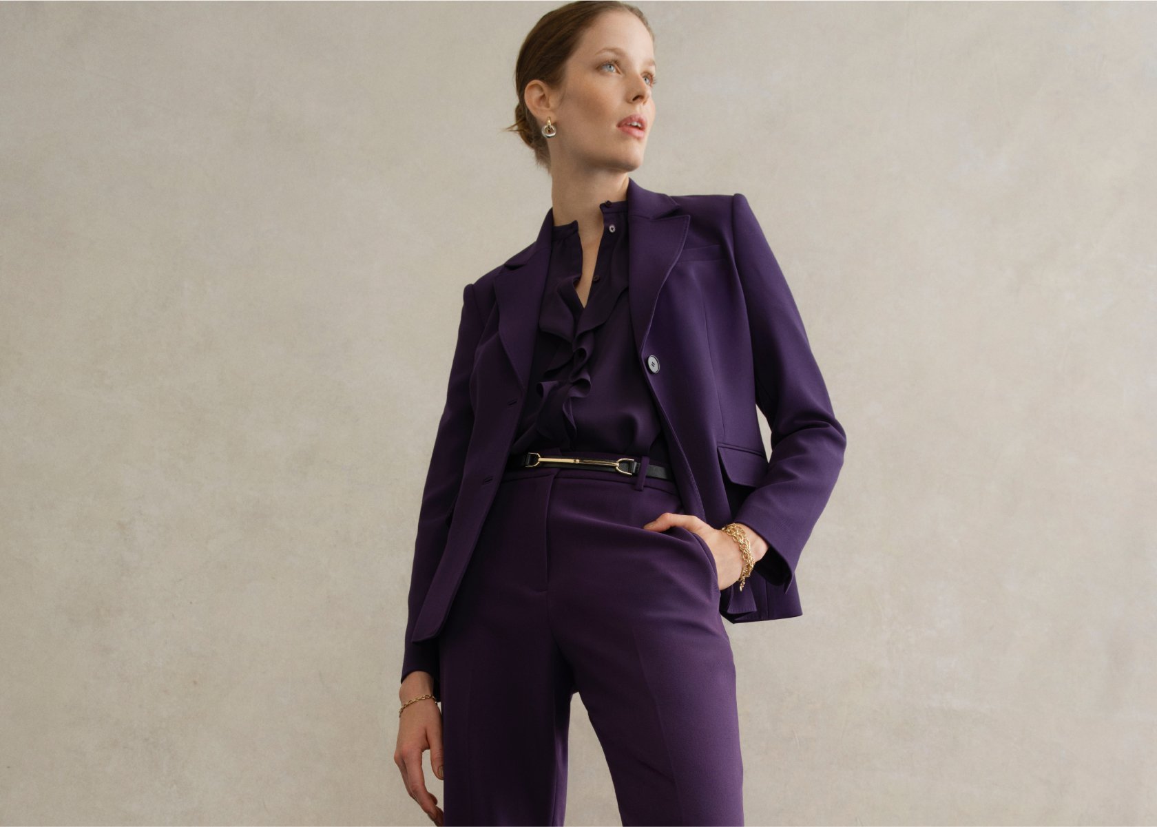 An image of a model wearing a women’s purple suit.