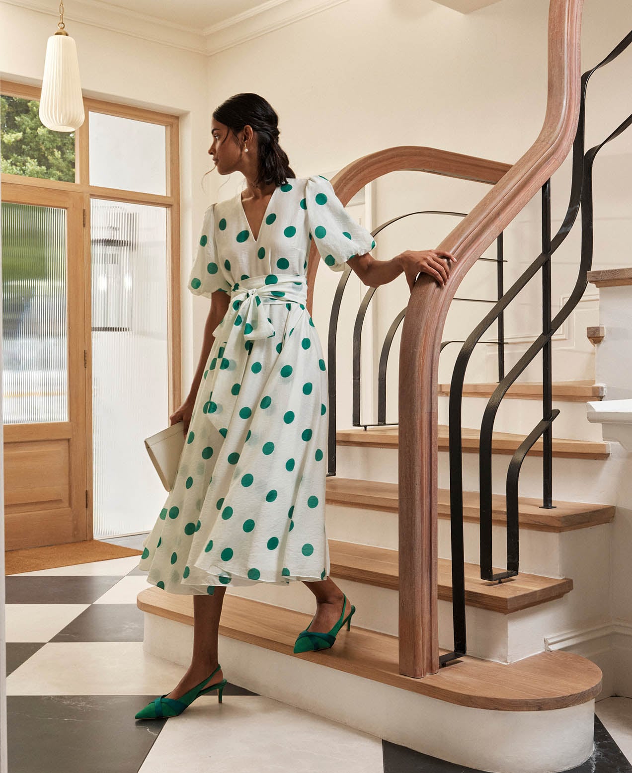 A woman wearing a Hobbs polka dot dress.