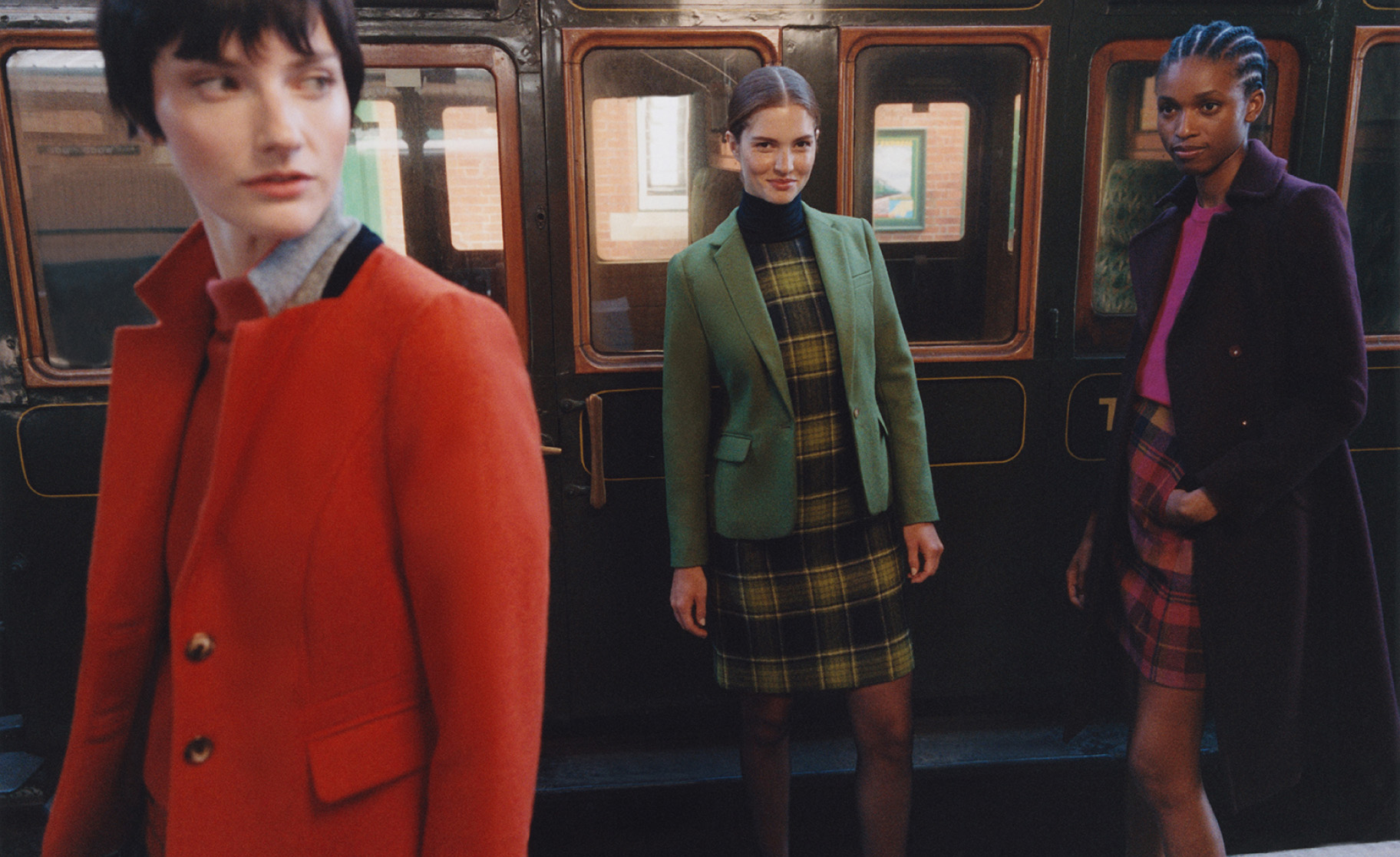 Hobbs models walk beside a heritage train wearing Abraham Moon tweed clothing.