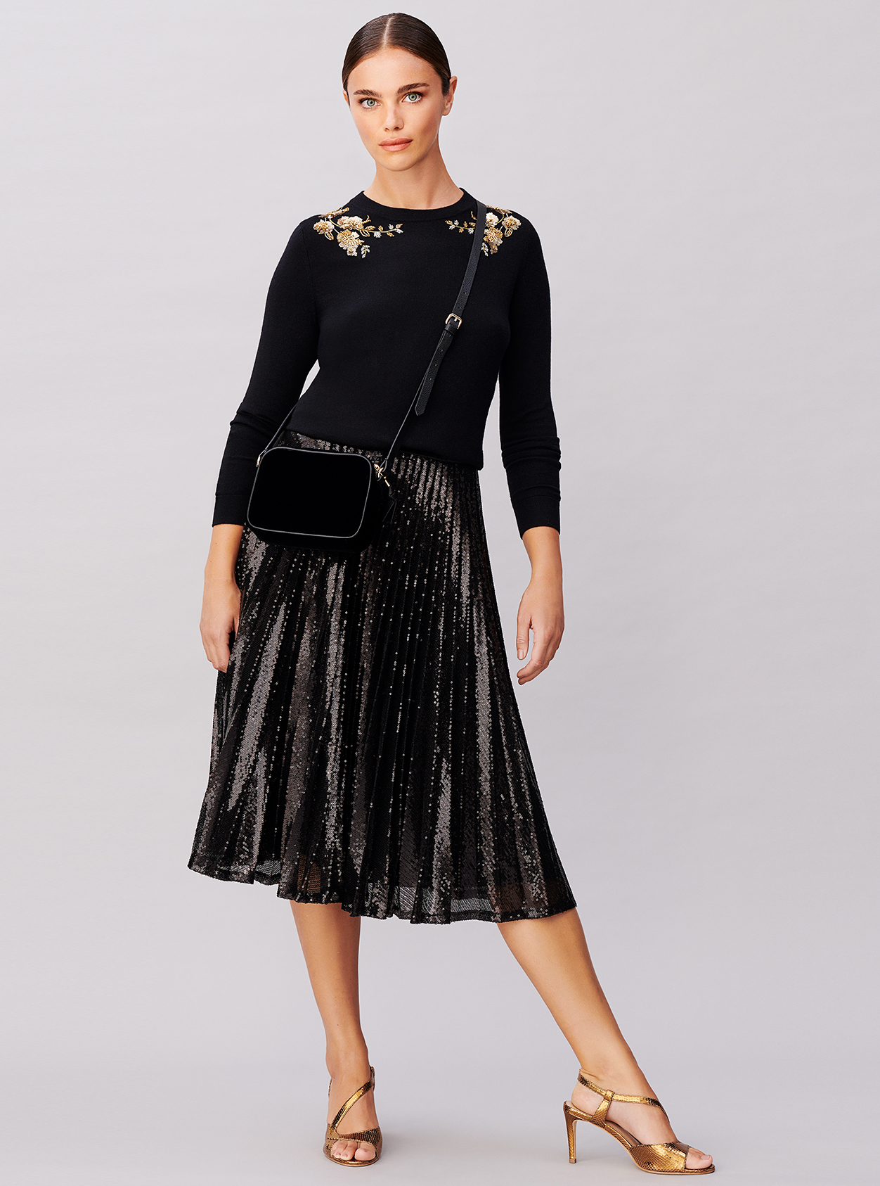 Sequin midi skirt worn with an embellished jumper, velvet crossbody bag and metallic heeled sandals from Hobbs.