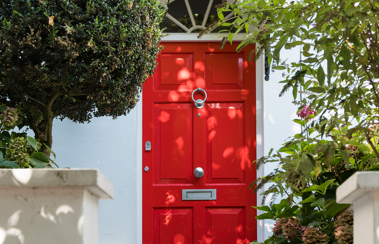 Hobbs at home with a class red london front door. 