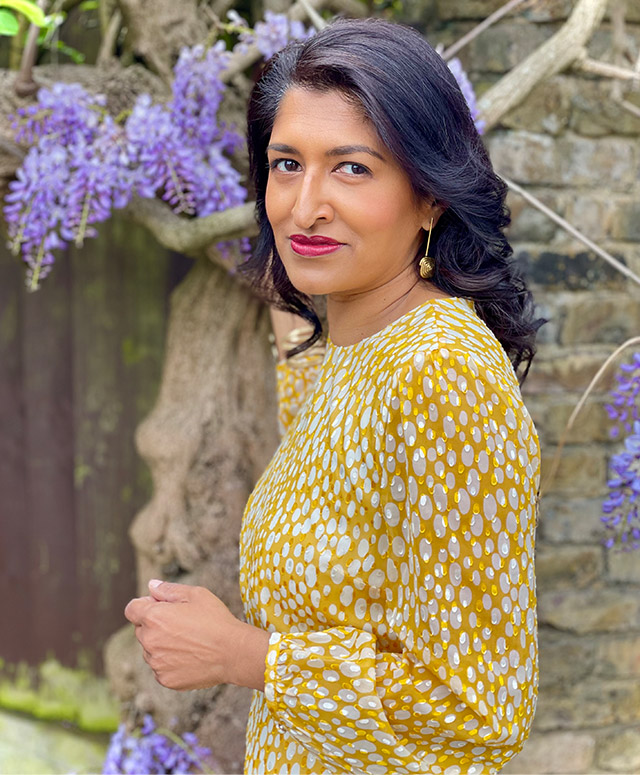 Fashion blogger @monikagoestowork photographed in her garden wearing Hobbs' Lexi yellow jacquard dress.