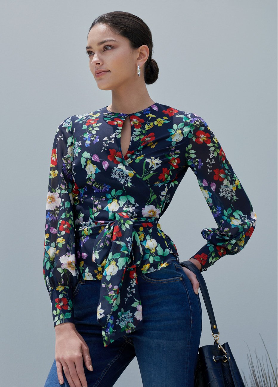 Floral wrap blouse with blue jeans and leather bucket bag by Hobbs.