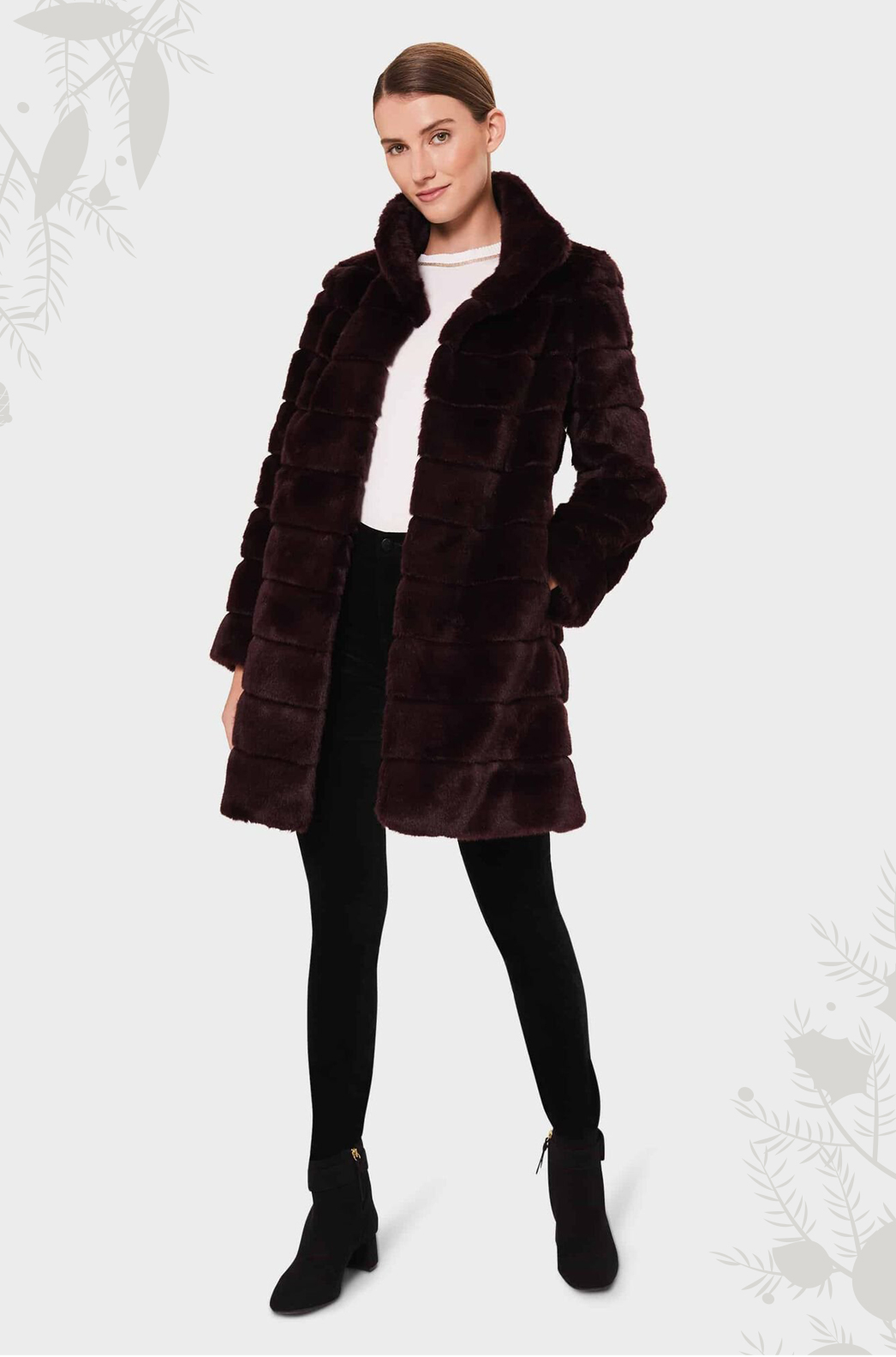 Model photographed wearing a dark burgundy faux fur coat.