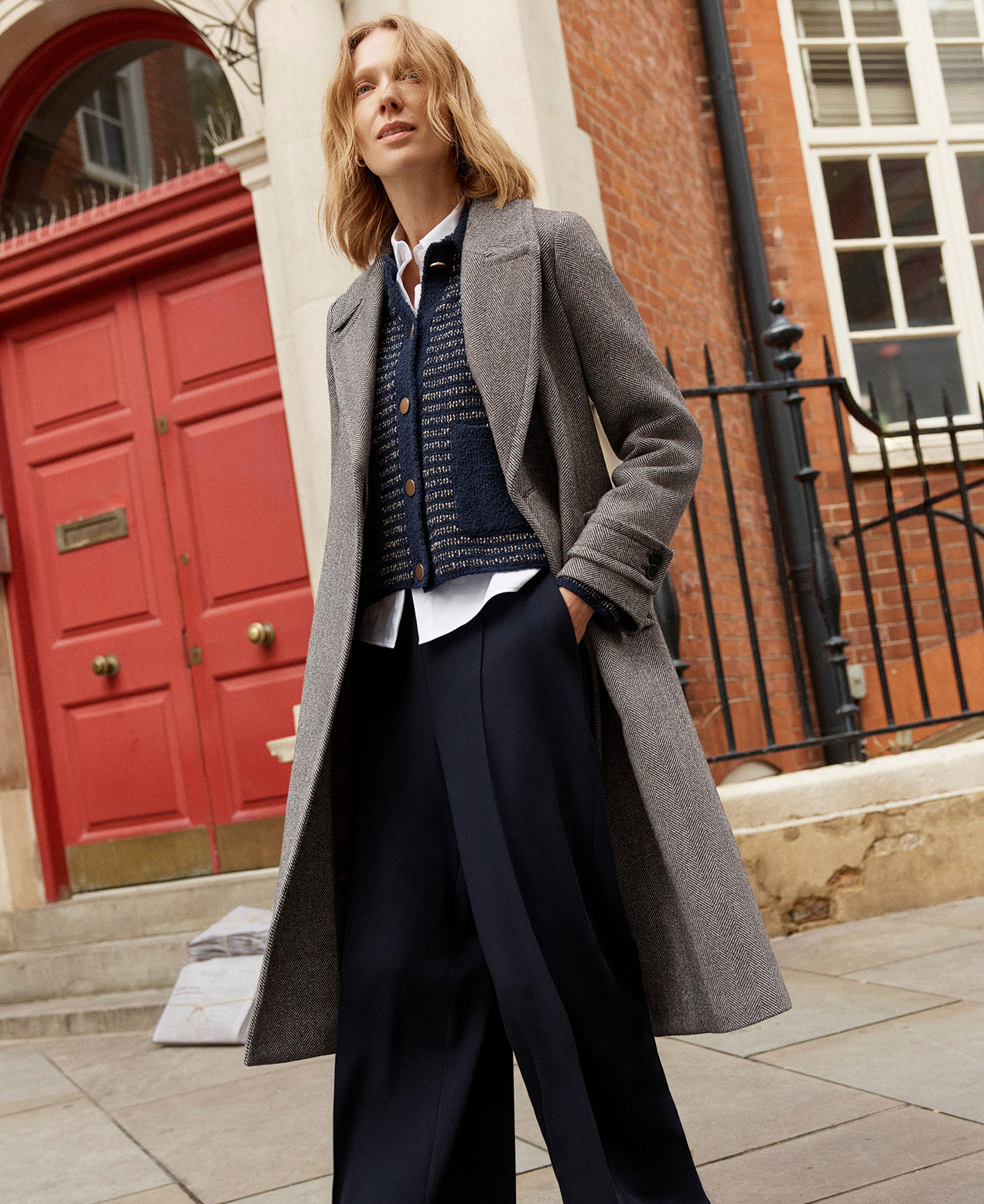 A woman wearing a mocha, tailored, wool blend coat.