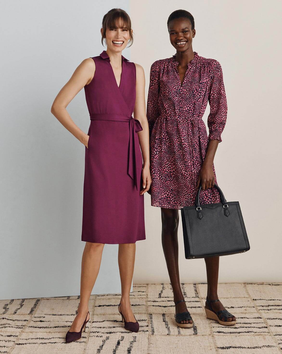 Two Hobbs models photographed wearing a plum wrap dress and pink leopard mini dress with coordinating accessories.