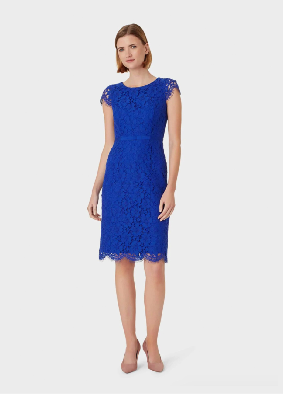 Lace shift dress in blue worn with nude court shoes by Hobbs.