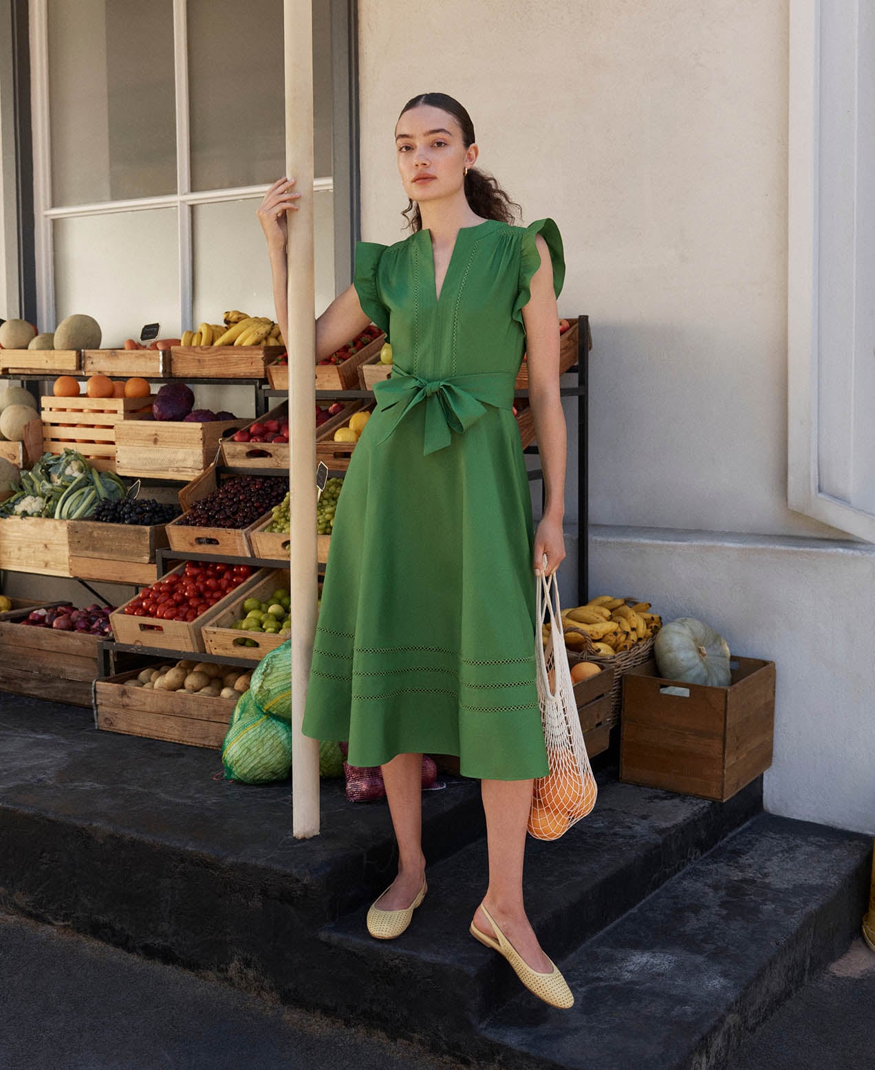 A woman wearing a Hobbs green dress.