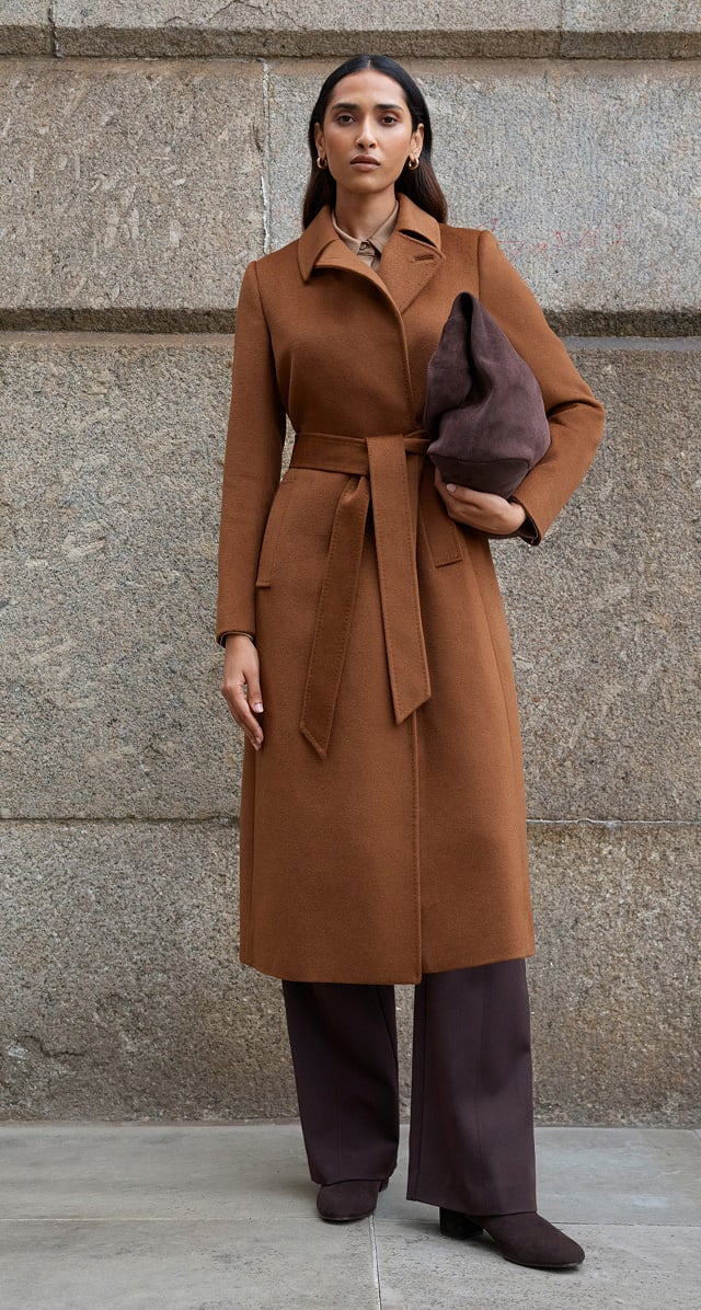 A woman wearing a Hobbs trench coat.