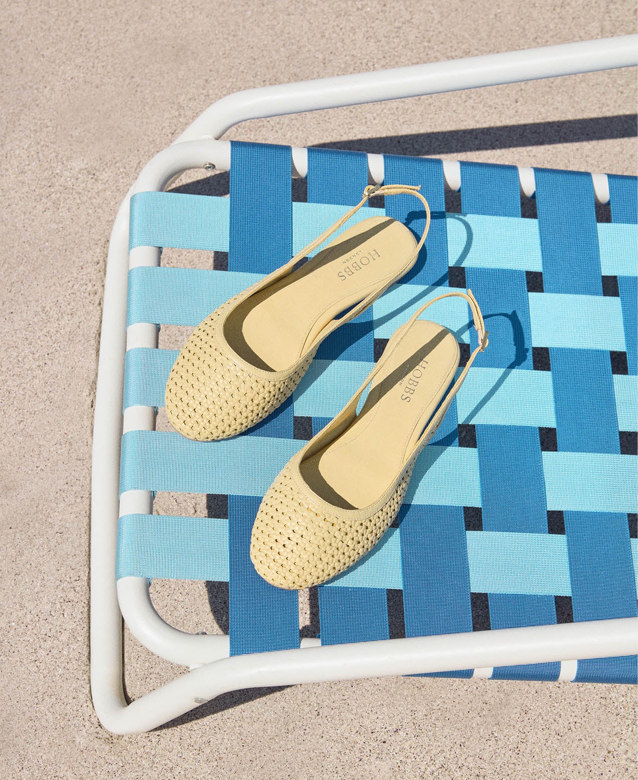 An image of Hobbs’ butter yellow sandals and bags