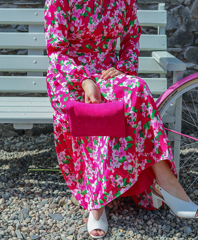 Fashion blogger @all.thats.pretty photographed in her garden wearing Hobbs' Marilyn pink floral midi dress with Kali ivory heels.