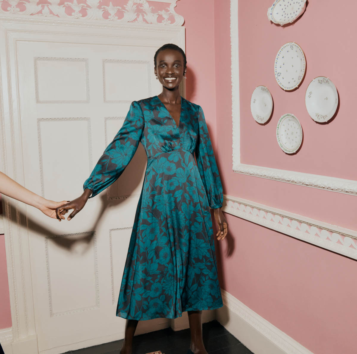 Image of a model smiling in a party dress.