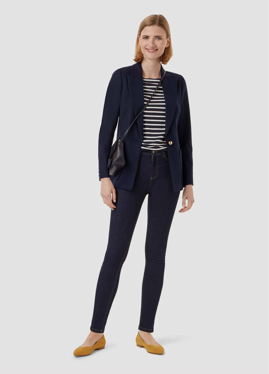 Women’s top with horizontal stripes in black and white, paired with a navy blazer, blue jeans and a crossbody bag in black, by Hobbs.