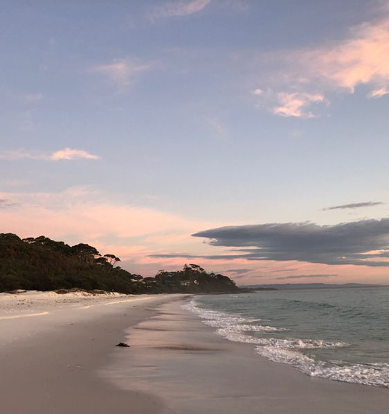 A serene beach scene with a pink and blue sky is evoked by Kavery Musgraves, Oh What A World.