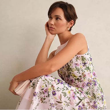 A woman wearing a blush pink occasion outfit.