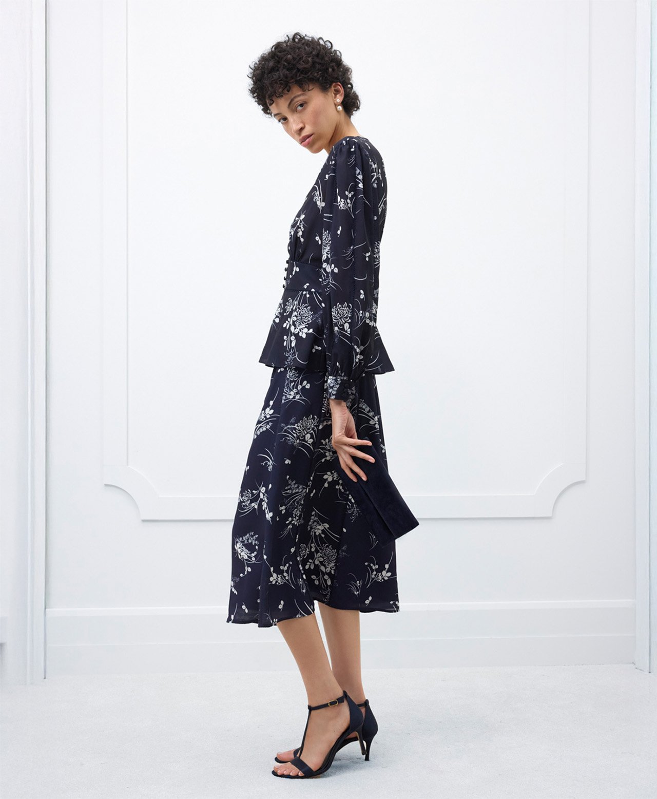 A woman wearing a contemporary, floral, Hobbs occasion co-ord