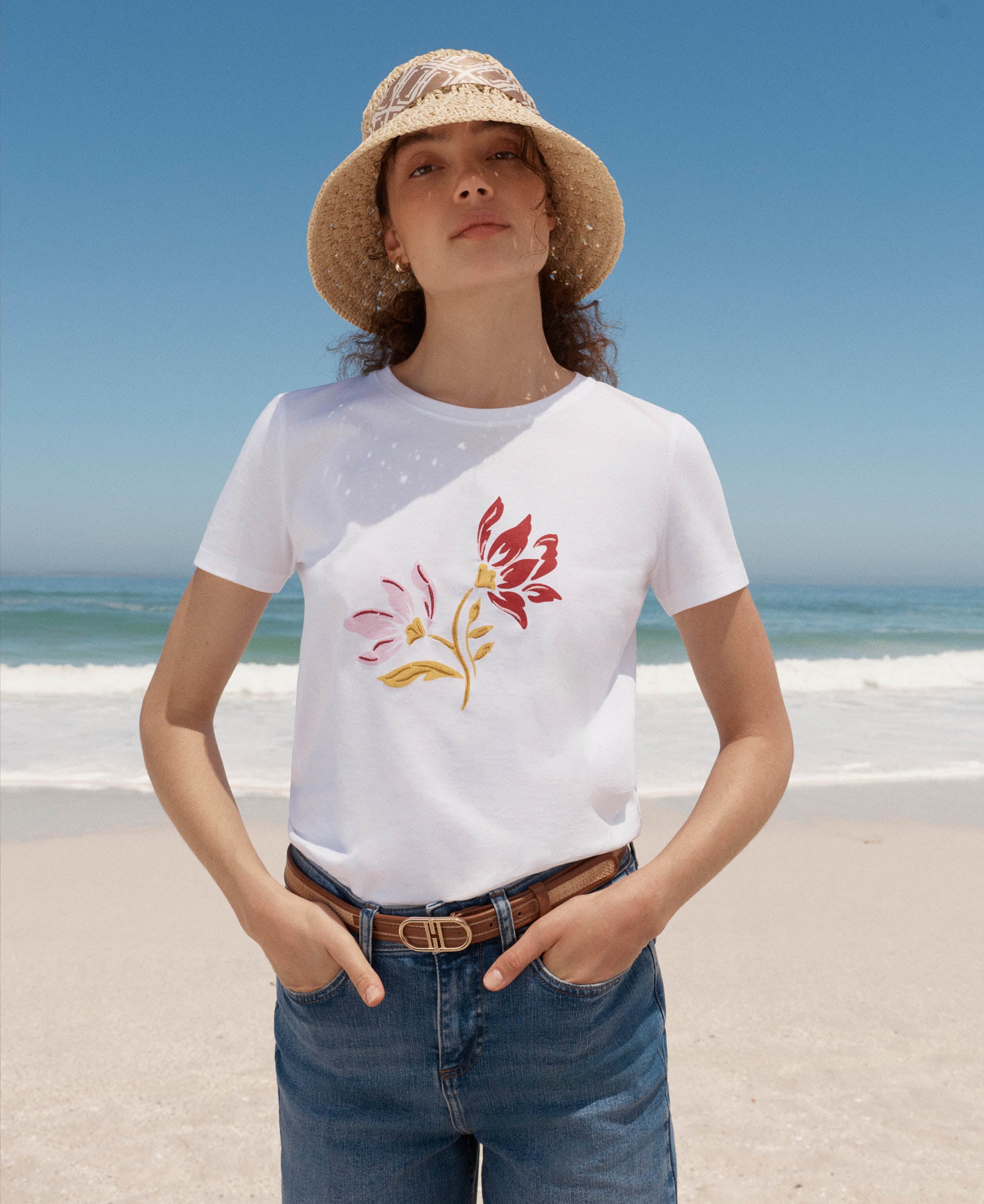 A woman wearing a Hobbs cotton t-shirt and denim jeans.