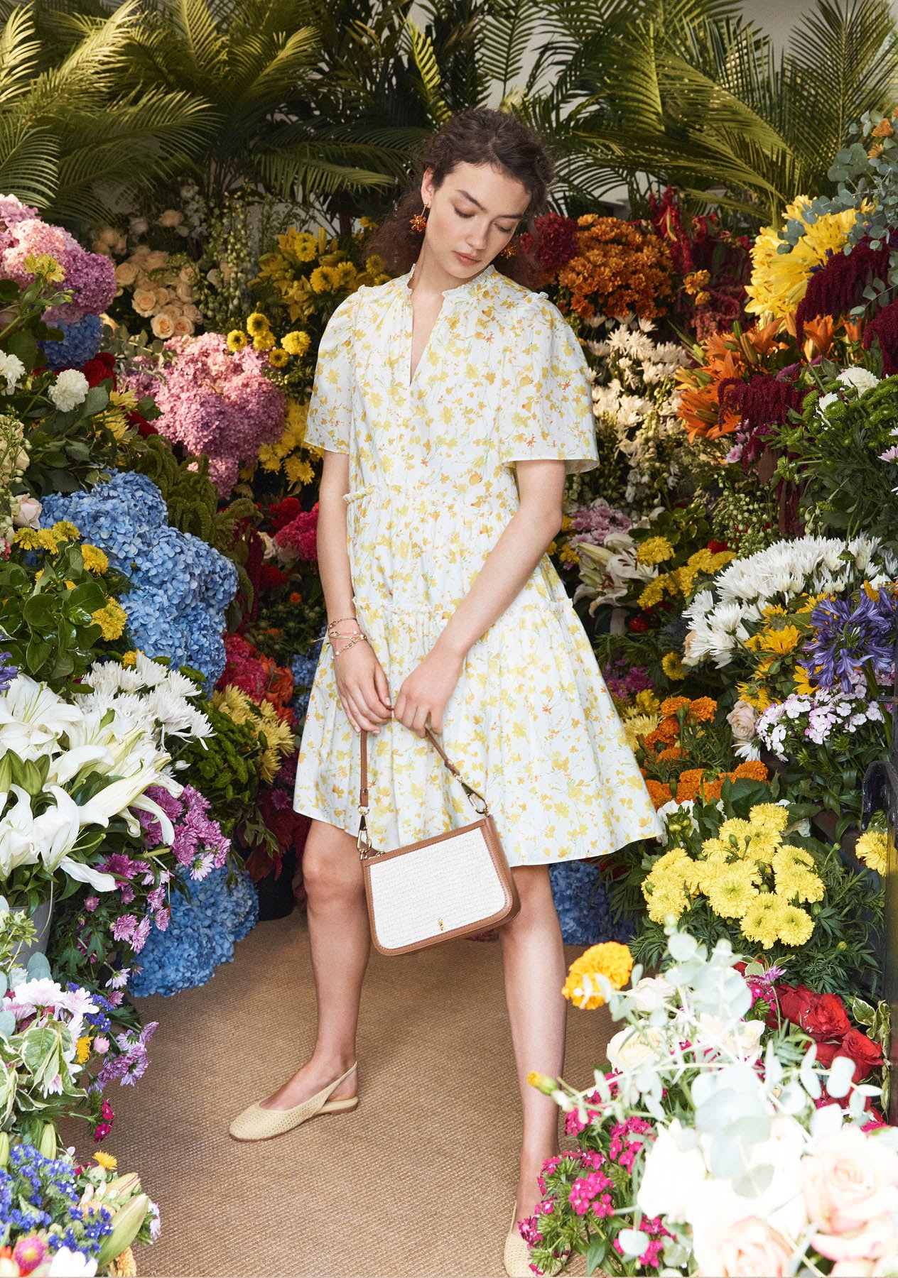 A woman wearing a Hobbs ditsy floral dress.
