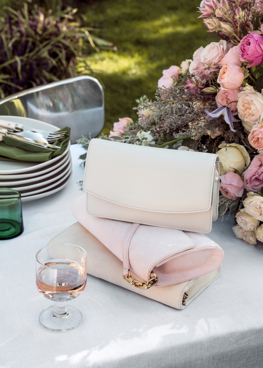 Image of clutch bags arranged on a table set for a wedding.
