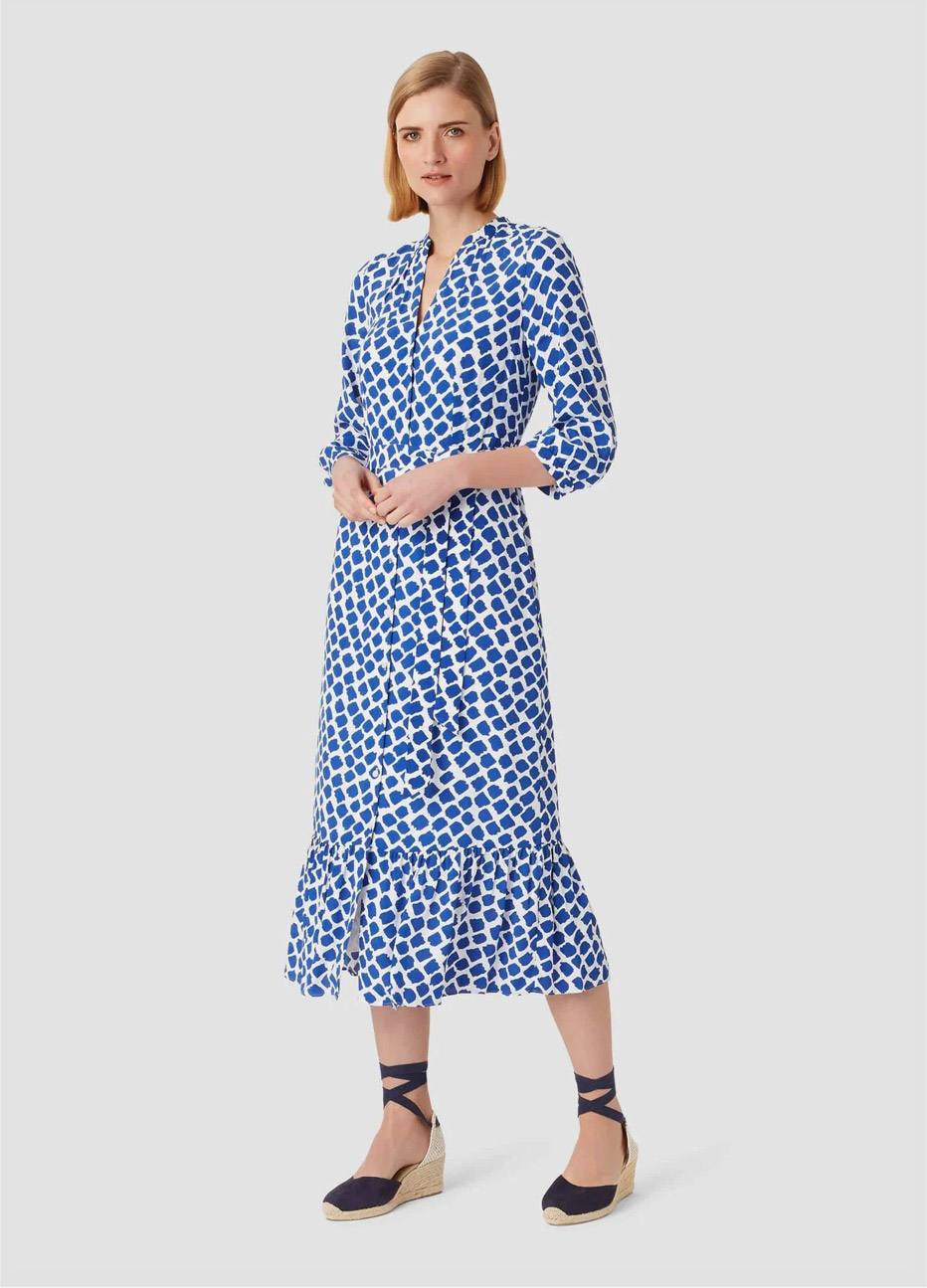 Midi length shirt dress with frill details in blue and white worn with espadrille wedge sandals by Hobbs.