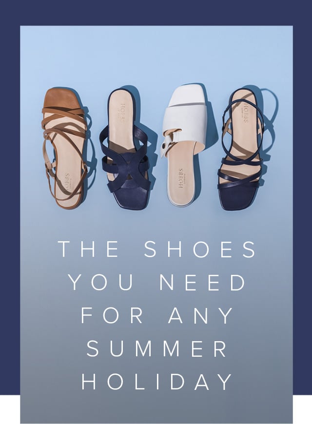 Four summer sandals from Hobbs against a blue background, from top to bottom: Brown sandal, dark blue sandal, white sandal, black sandal.