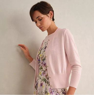 A woman wearing a blush pink occasion outfit.