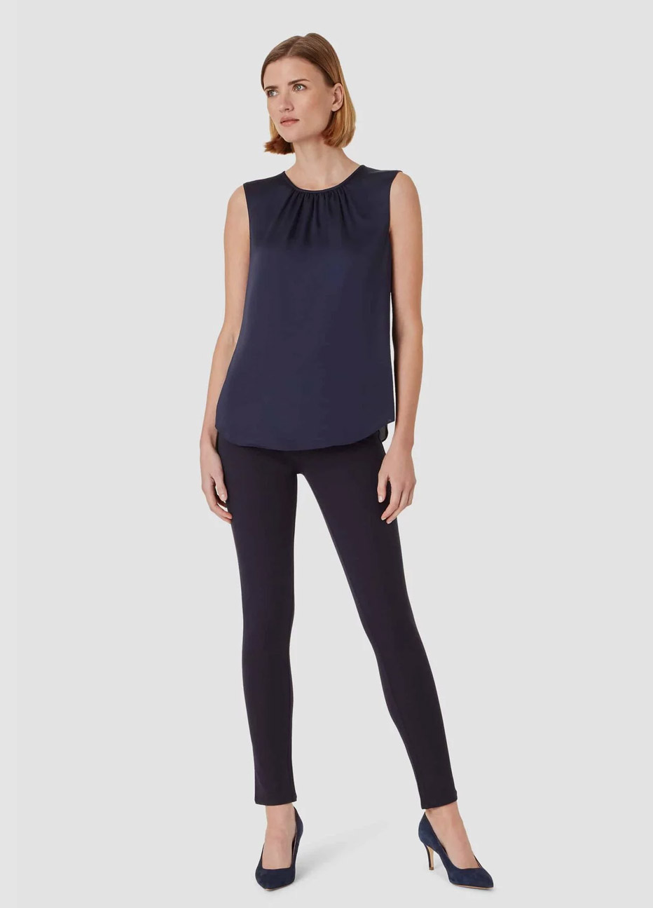 Satin blouse in navy worn with navy jeans by Hobbs.
