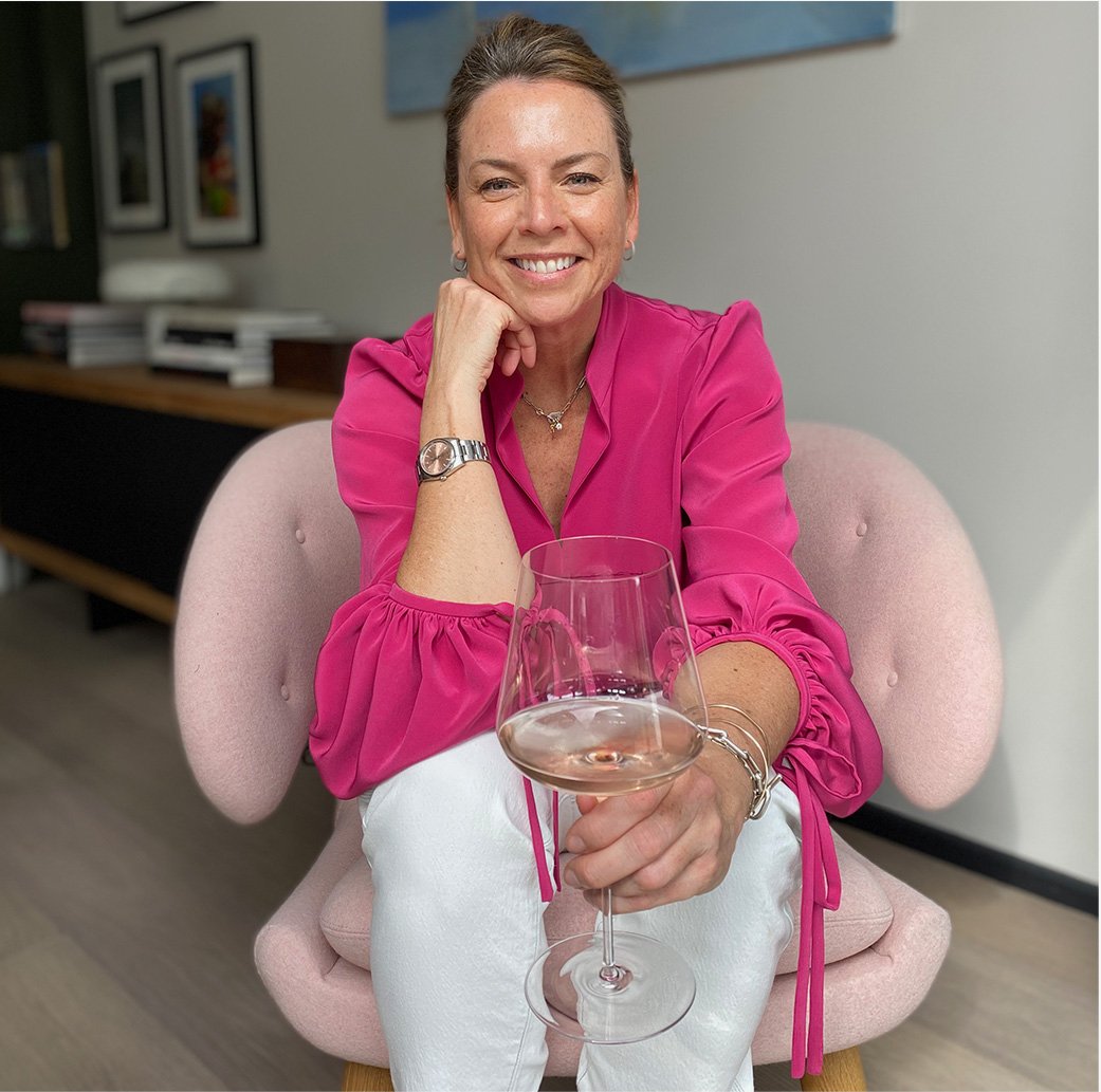 Sally Ambrose, Hobbs Product Director pictured at home in a pink blouse and white jeans 