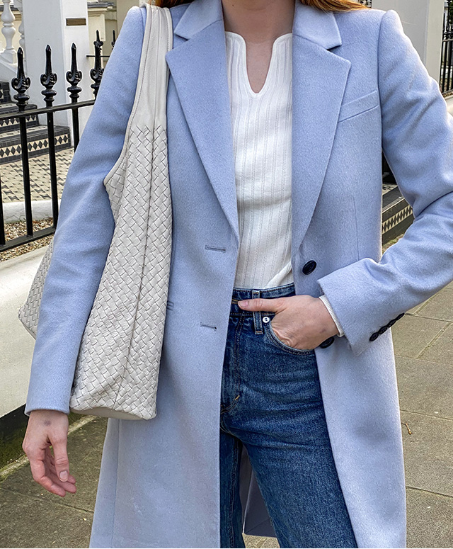 Fashion blogger @mollie_moore__ photographed on a walk wearing Hobbs Tilda blue coat, Vanessa jumper,Sukey jeans and Freda trainers.