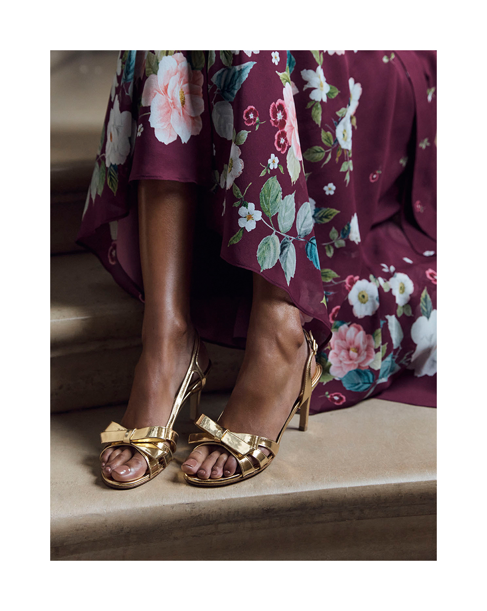 Close-up on Hobbs model wearing gold sandals.