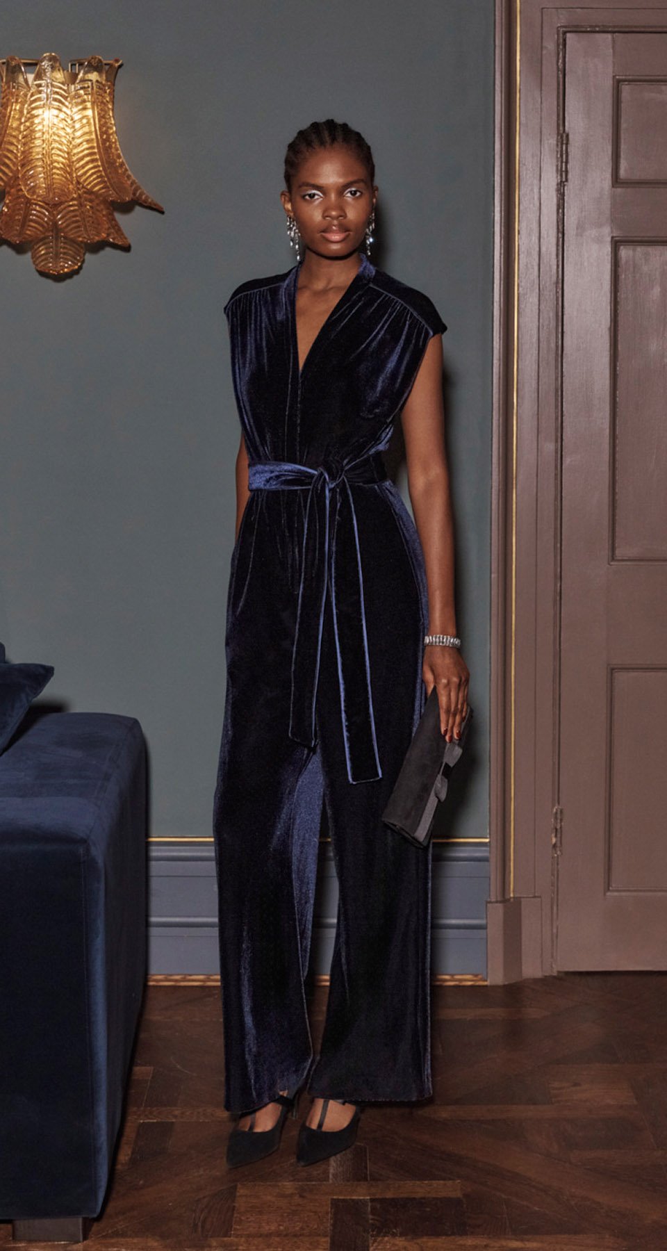 A woman wearing a Hobbs Velvet Jumpsuit.