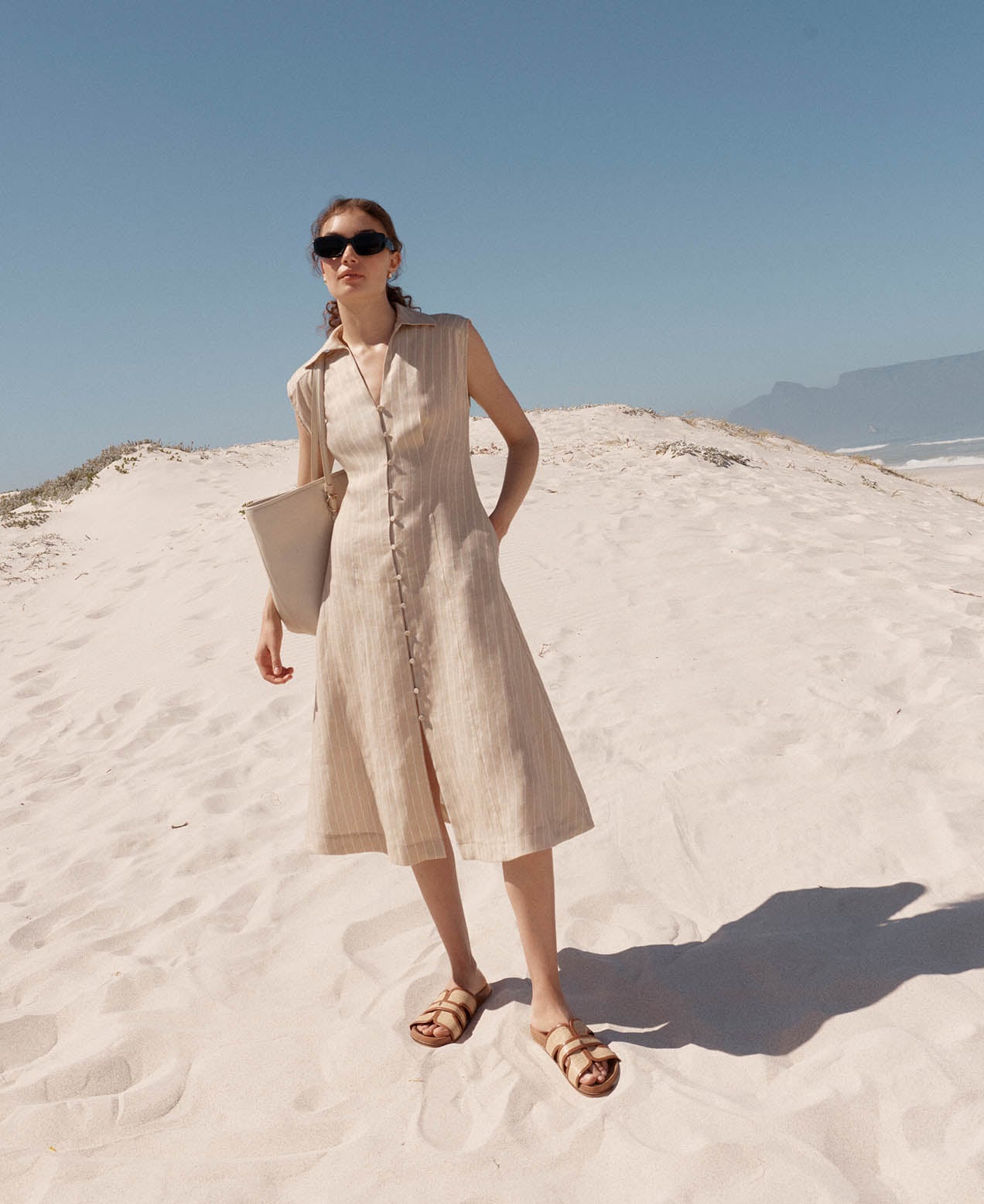 A woman wearing a Hobbs broderie tunic dress