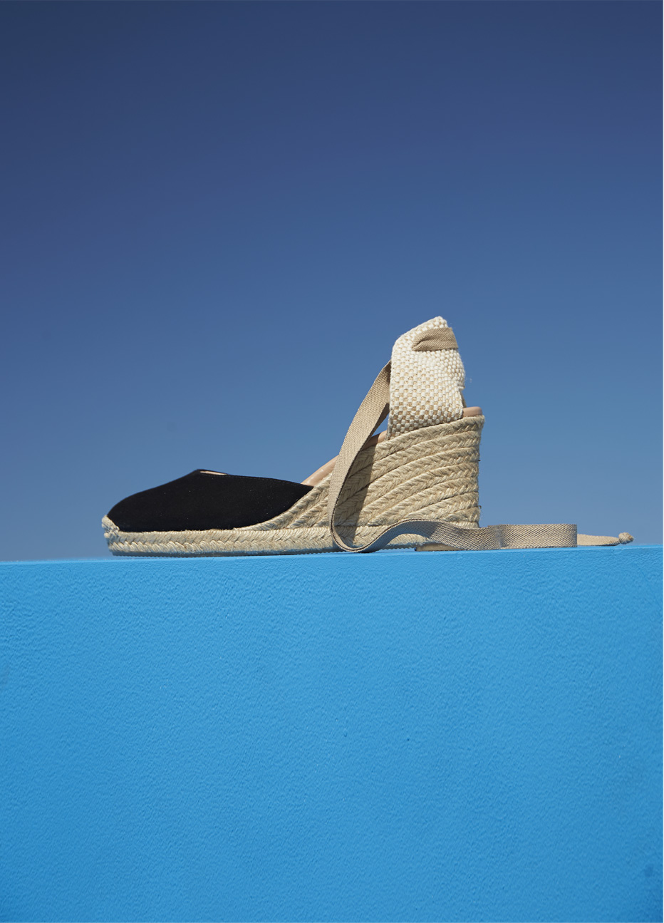 Espadrille wedge sandal in black with an ankle strap feature by Hobbs. A versatile choice, wear with a formal dress or a floral dress for all types of events.