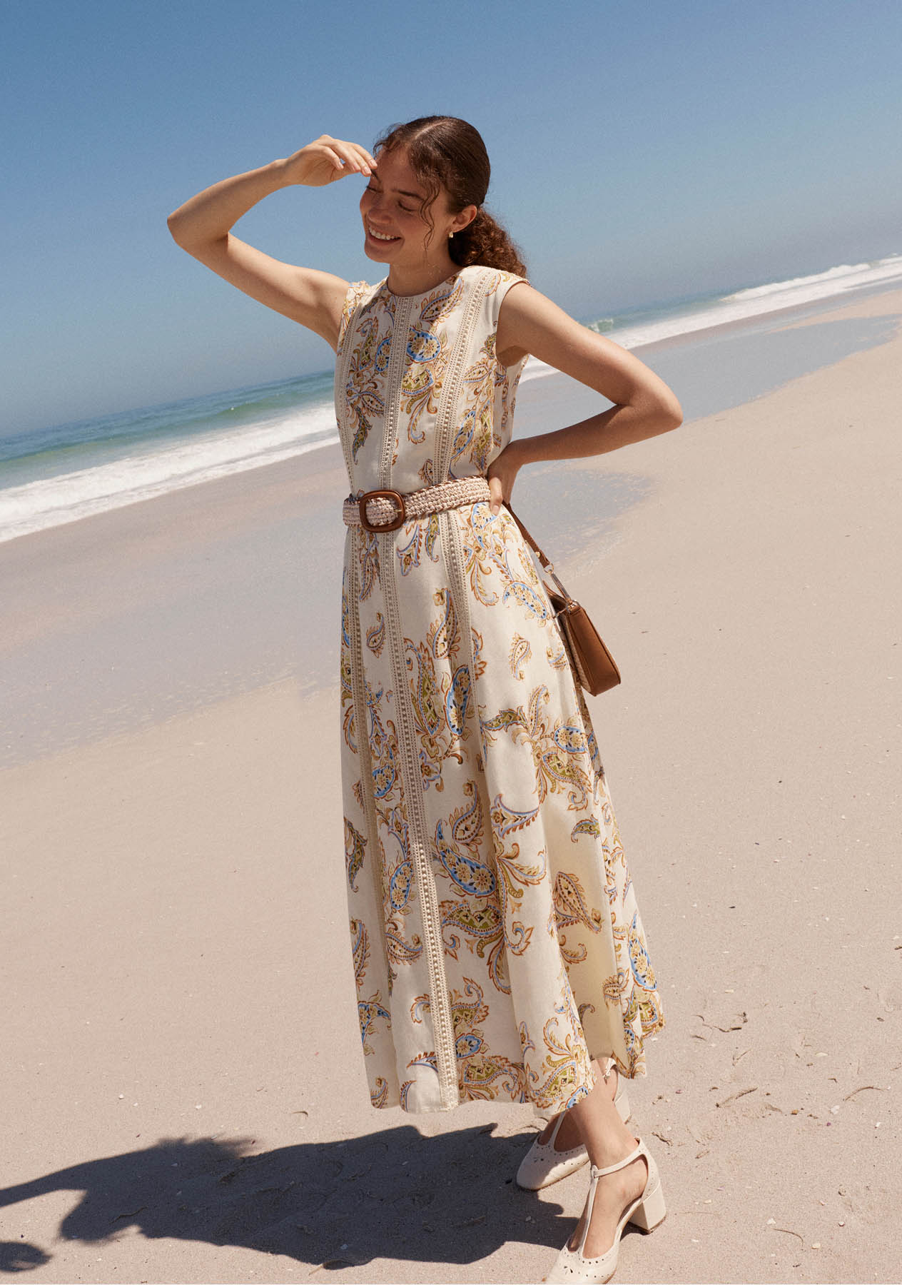 A woman wearing a Hobbs linen paisley dress.