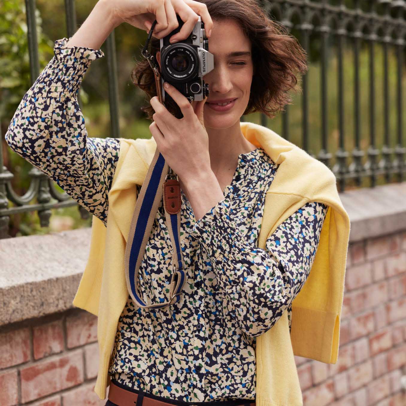 Image of model taking a photo wearing a Hobbs casual outfit.