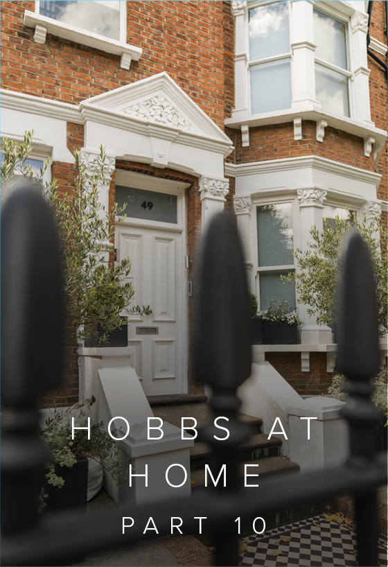 A red brick Edwardian house with a white front foor with a black and white tiled stairs