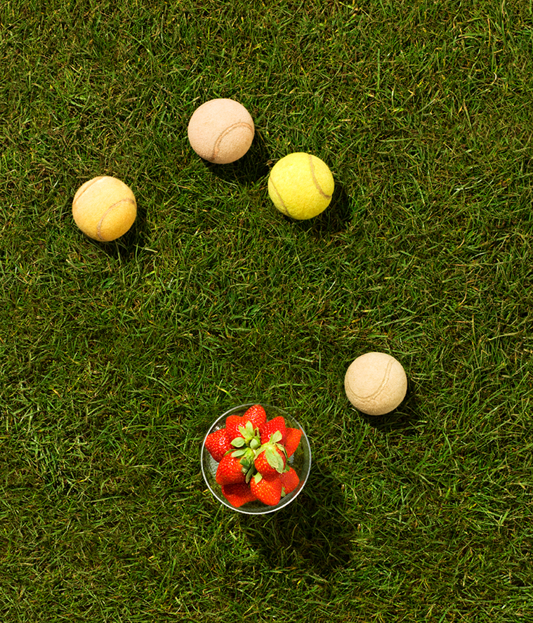 Flatlay with strawberries and tennis balls